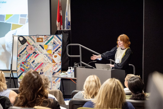 Carole Rankin shows off the Community Threads quilt at Birth Con. Photo by Ryan Wilson IWK.