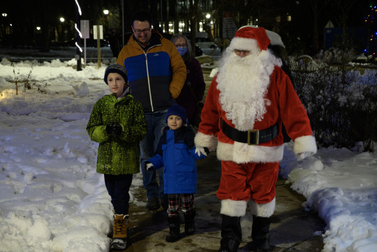 Santa walking with Calum and Lauchlin holding hands