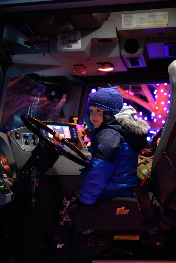 Calum stilling at the steering wheel of a fire truck