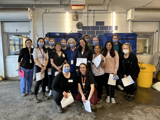 Group of decontamination trainees and trainers pose together with their training certificates