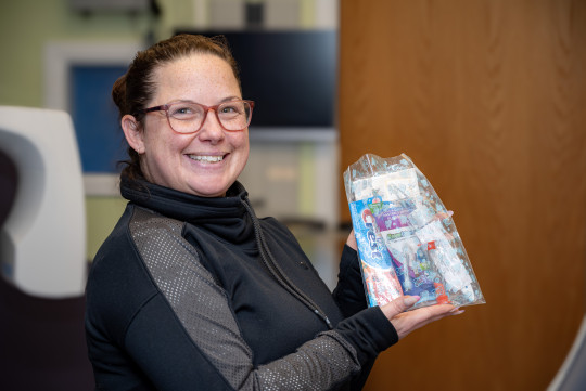 Jenna Shields holds up one of the dental kits being given out.