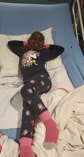 Karahella Ady poses as she lies in a hospital bed.
