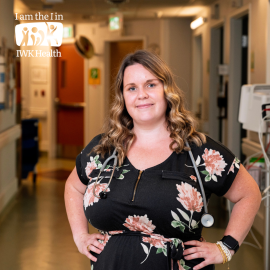 Patti Douglas stands in a hospital hallway, hands on hips.