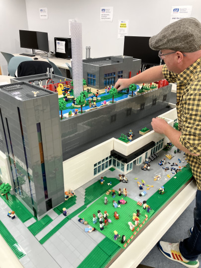 Shawn McLeod puts the finishing touches on the LEGO model of the upcoming emergency department at IWK.