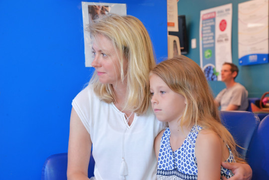  Rebecca MacKay sits with her daughter in an emergency room.