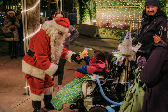 Santa greets child in wheelchair
