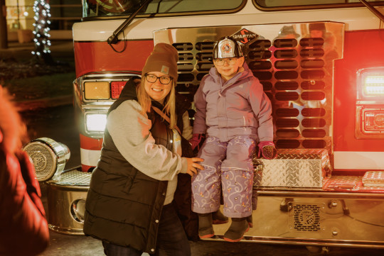 Isla sits on a Firetruck