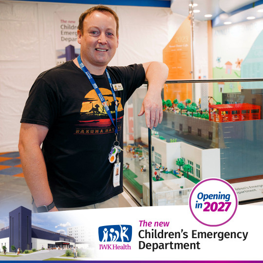 Matt Hunter stands by a lego model of the new emergency department being built at IWK.