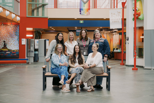 A group of Clinical Nurse Specialists sit together in the IWK Goldbloom Pavillion.
