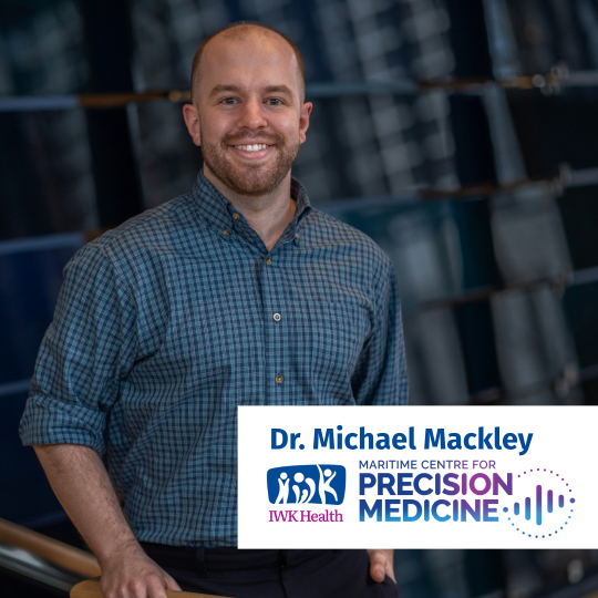 Dr. Michael Mackley stands in front of a dark background.