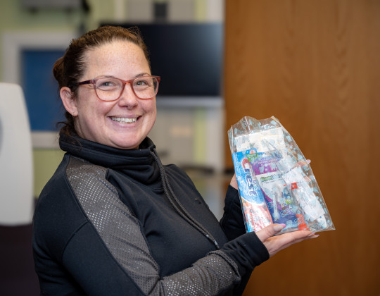 Jenna Shields holds up one of the dental kits being given out.
