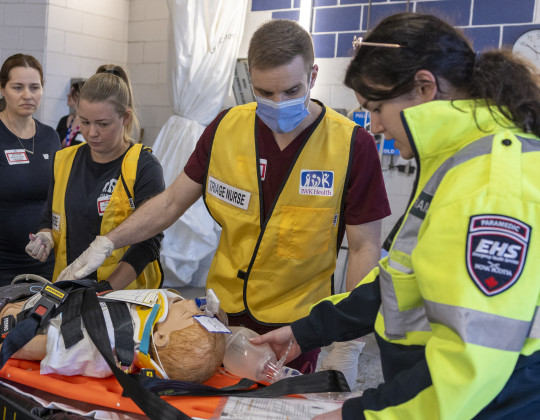 Triage nurses and EHS responder assisting a simulartion dummy