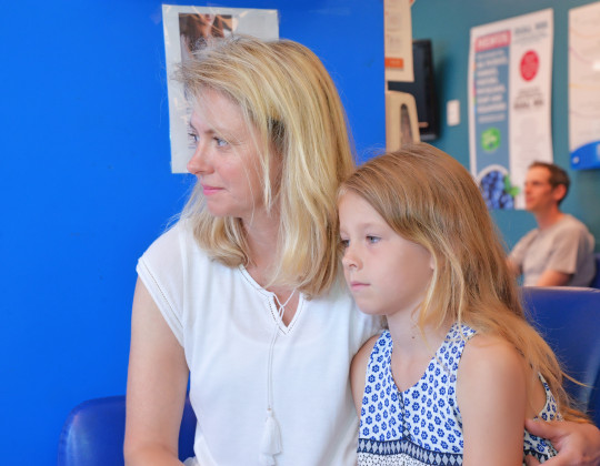  Rebecca MacKay sits with her daughter in an emergency room.