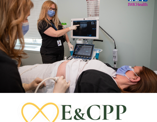 A doctor points to an ultrasound display as a woman lies on the bed.