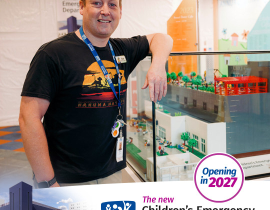 Matt Hunter stands by a lego model of the new emergency department being built at IWK.