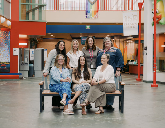 A group of Clinical Nurse Specialists sit together in the IWK Goldbloom Pavillion.
