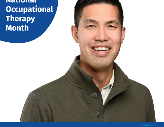 Scott Thieu in a green button v-neck sweater.